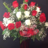 2 dozen roses in a vase with babies breath