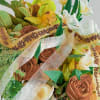 Alright, this bouquet? Next-level classy. Think warm caramel roses, golden orchids, and