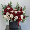 A captivating vase arrangement intertwining the passionate red roses with the delicate