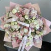 This bouquet featuring spray roses and ranunculus offers a beautifully layered, textured