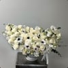 This is an elegant and refined floral arrangement in a soft, neutral