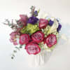 This brightly colored pink and purple vase arrangement is accentuated with a