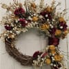 This beautifully handcrafted wreath features a stunning arrangement of naturally dried roses