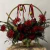 This elegant arrangement showcases a lush mix of Peonies, roses, Lilies, and
