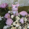 This enchanting Christmas arrangement features Peonies, Lilies, and Roses, complemented by seasonal