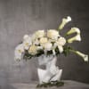 The &quot;Elsa&quot; flower arrangement features elegant white calla lilies, orchids, and roses