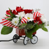 Send your loved ones holiday cheer in a jolly red wagon! This