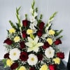 Beautiful arrangement with 12 red roses and mixed colors.