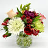 This small yet striking floral arrangement bursts with the bold, fiery colors