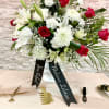 This elegant and serene floral arrangement combines the purity of white lilies