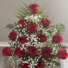 This stunning floral arrangement contains red roses, baby&rsquo;s breath flowers, leather leaf
