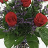 1/2 dozen Red roses with lush green and purple misty limonium arranged
