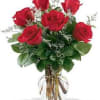 Six lovely roses arranged in a vase with pretty aster and greens