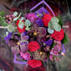 A striking bouquet designed to captivate with its dramatic colors and intricate