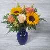 Sunflowers, Roses, Filler in a beautiful cobalt blue vase. 