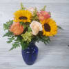 Sunflowers, Roses, Filler in a beautiful cobalt blue vase. 