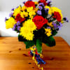 Red carnations, yellow daisies, purple Monte Casino blooms and green button poms
