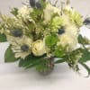 A lovely mix of white roses, spider mums, thistle, and other seasonal
