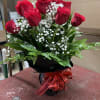 One dozen red roses arrangement with baby breath and leather leaf