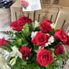 A combination of 12 red roses vase arrangement with white alstroemerias, leather