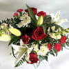 Cute red jar vase filled with hydrangeas, lilies, eucalyptus, roses, mums and