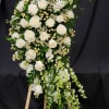 A stunning and graceful white sympathy standing spray, designed to express heartfelt
