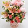 Includes Lillies, roses, carnations, Alstroemeria, white aster, wax pink, mixed greenery and