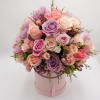 Different shade of pink flowers are carefully arranged inside the flower box.