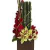 Yellow cymbidium orchids, red gladioli and yellow leucadendron are presented in a