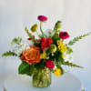 A bright, fun, seasonal arrangement showcasing our current favorite locally grown blooms.