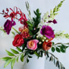 A bright, fun, seasonal arrangement showcasing our current favorite locally grown blooms.