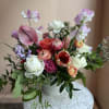A bright, fun, seasonal arrangement showcasing our current favorite locally grown blooms.