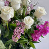 2 dozen white roses with pops of pink stock and wax flowers.

Colors