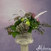 Antique hydrangea, dried grasses, veronica, lavender roses and green carnations swirl around