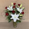 A spectacular arrangement including a dozen beautiful long-stemmed red roses with white