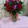 Red roses with a hint of purple complete this precious bouquet.
