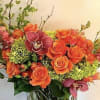 Send a refreshing splash of orange roses with orchids.