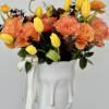A captivating arrangement nestled within an elegant vase, featuring a delightful mix