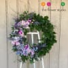 A beautiful round shape / wreath, accented with lavender roses, orchids, 