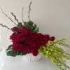 Designer arrangement roses and orchids in a designer box that enhances their
