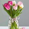 A delicate arrangement featuring 10 mixed tulips in soft pastel tones, elegantly
