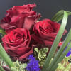 A sweet little bouquet with red roses and creative flare.