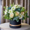 A round hat box of pretty sage and mint greenery. White daisies
