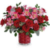 This Valentine&#039;s Day arrangement features red spray roses, pink alstroemeria, and miniature
