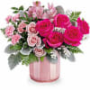 This Valentine&#039;s Day arrangement showcases hot pink roses, pink spray roses, pink