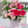 This Valentine&#039;s Day arrangement showcases hot pink roses, pink spray roses, pink