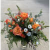 A beautiful whispy boho style arrangement of free spirit roses, orange spray