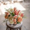 Here luxurious roses in a peachy terracotta tone accompany muted ivory and