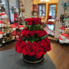 3 tiers of roses arranged inside a round flower box.