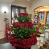 3 tiers of roses arranged inside a round flower box.